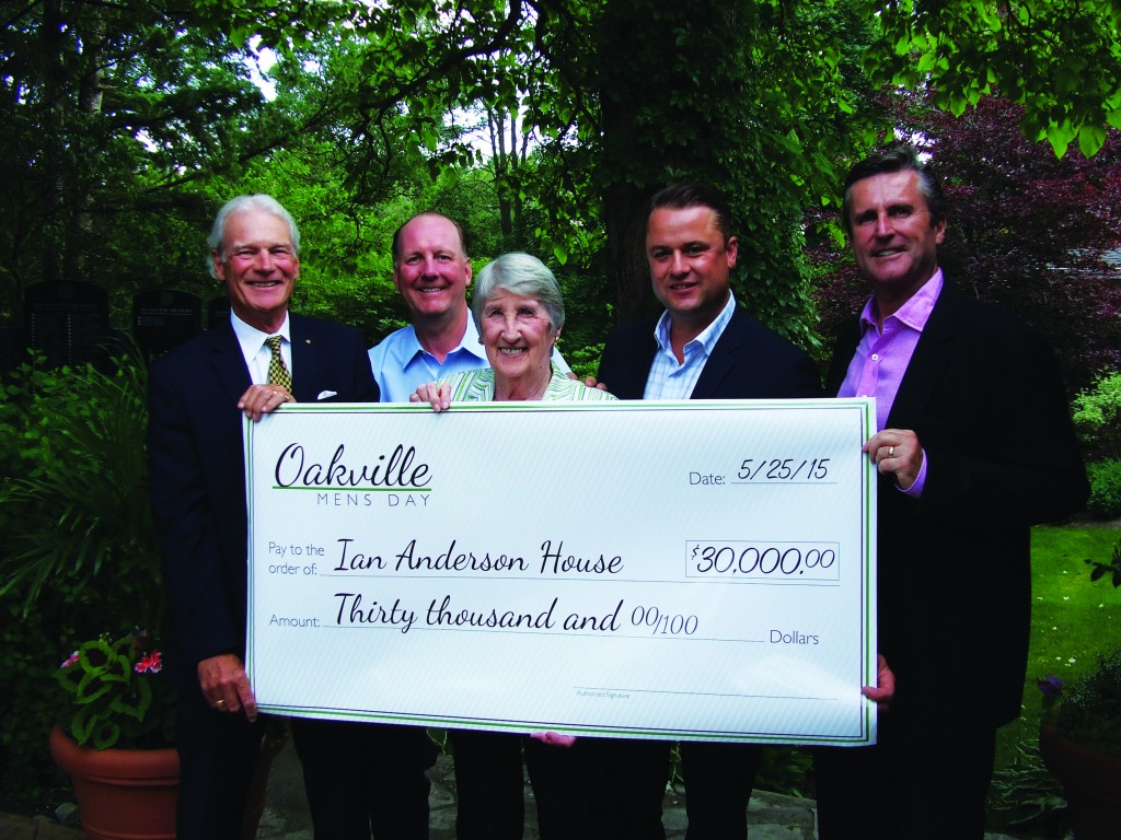 Four business men and a lady holding a big cheque