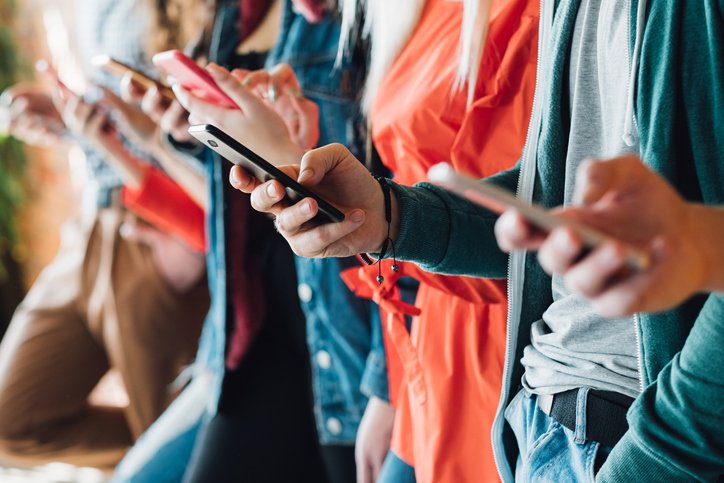 Cropped closeup of millennials using smartphones