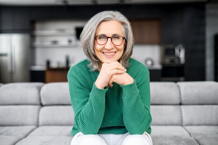 Healthy aged woman sitting on the sofa