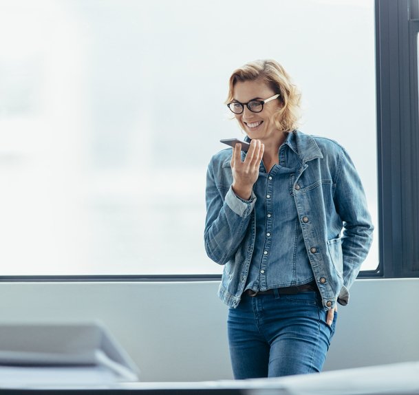 female executive talking on speaker phone