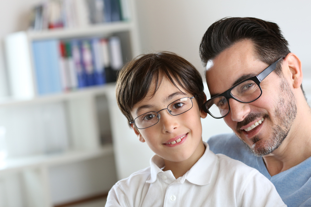 Portrait of young boy with daddy with eyeglasses on